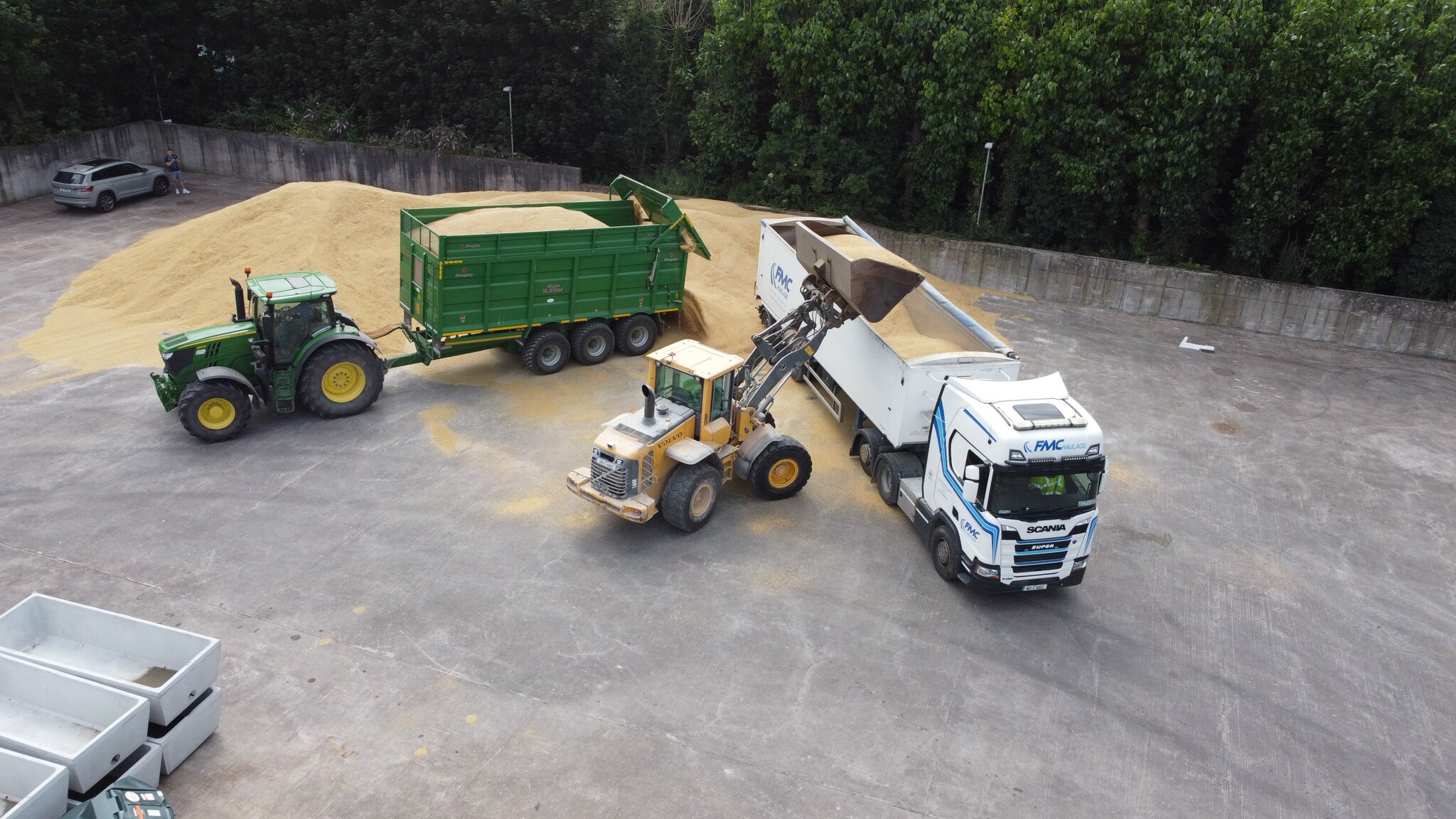 FMC Haulage Scania tipper, Volvo wheel loader and tractor working a grain harvest at the Ovens yard