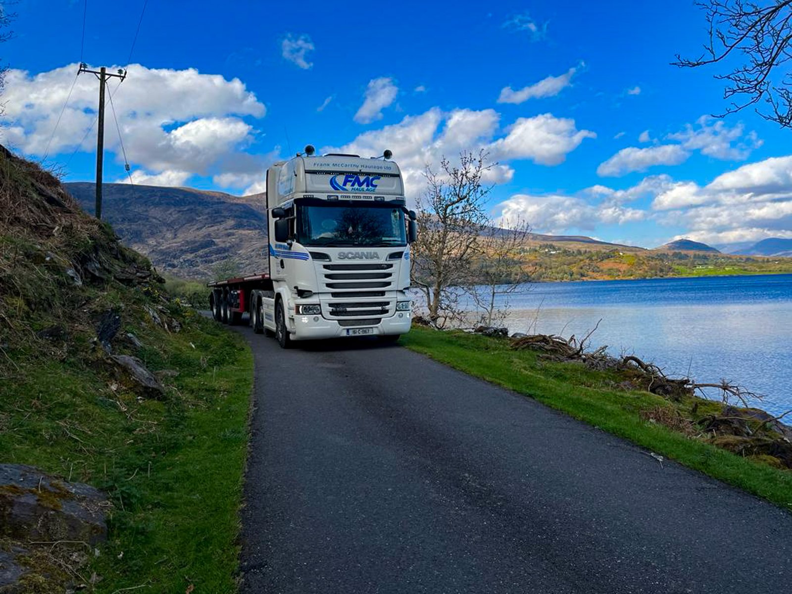 FMC Scania with flat trailer on a Cork lakeshore road